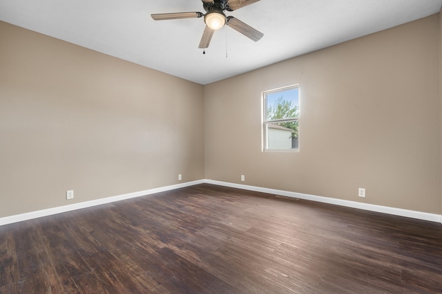 spare room with ceiling fan and dark hardwood / wood-style flooring