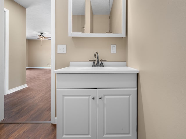 bathroom featuring hardwood / wood-style flooring, ceiling fan, and vanity