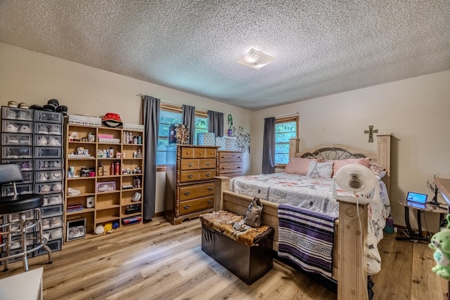 bedroom featuring a textured ceiling and light wood-type flooring