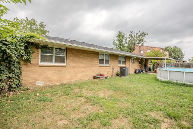 back of property featuring a yard and cooling unit