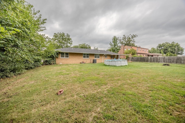 view of yard with a fenced in pool