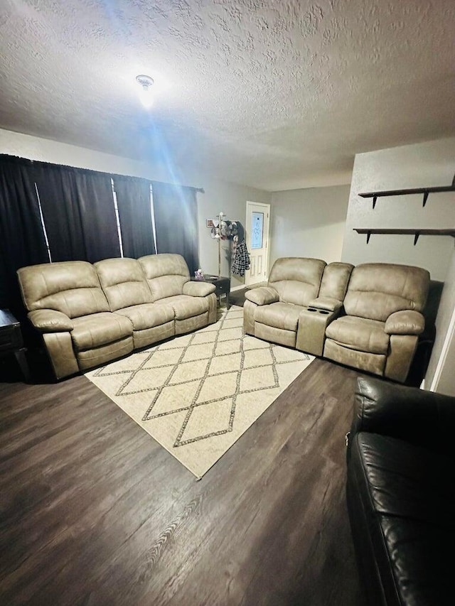 living room with hardwood / wood-style flooring and a textured ceiling