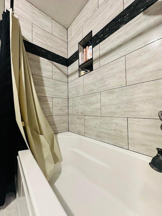 bathroom with shower / bath combo with shower curtain