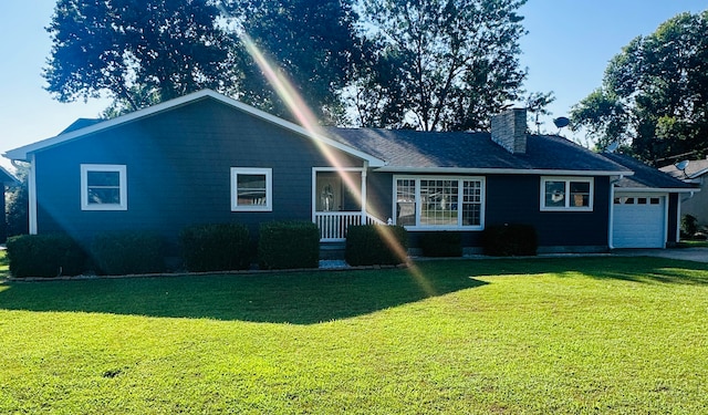 view of front of property with a front yard and a garage