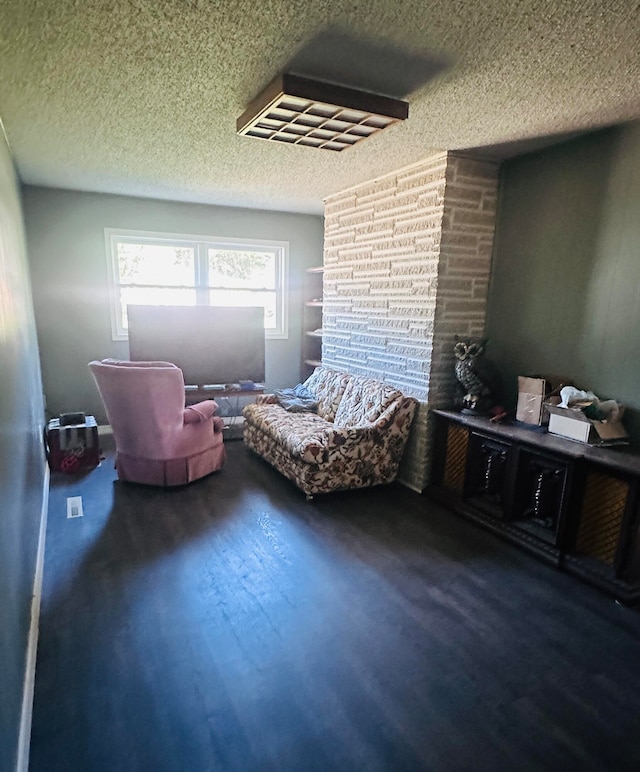 living area with a textured ceiling