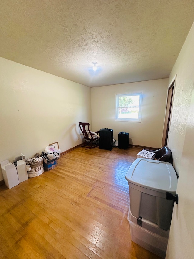 misc room featuring hardwood / wood-style flooring and a textured ceiling