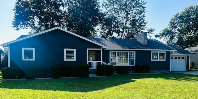 view of front of home with a front lawn and a garage