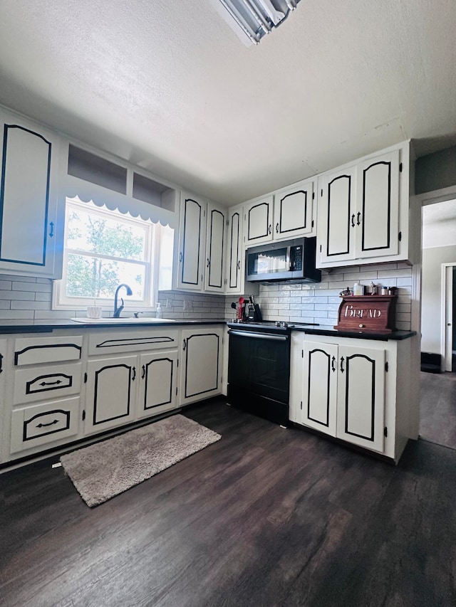 kitchen with dark wood-type flooring, range with electric cooktop, and decorative backsplash