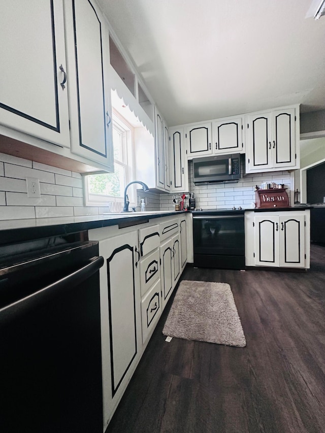 kitchen with black appliances, dark hardwood / wood-style floors, white cabinets, sink, and backsplash