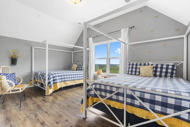 bedroom featuring wood-type flooring and lofted ceiling