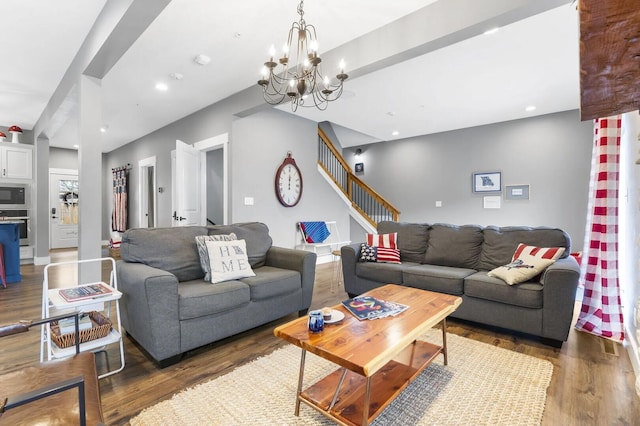 living room with a chandelier and dark wood-type flooring