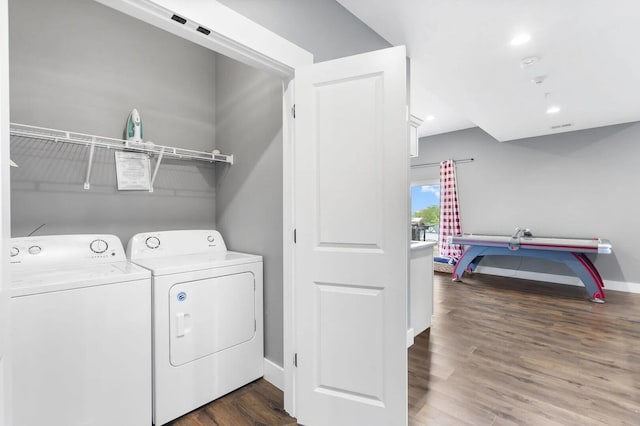 washroom featuring dark wood-type flooring and washer and dryer