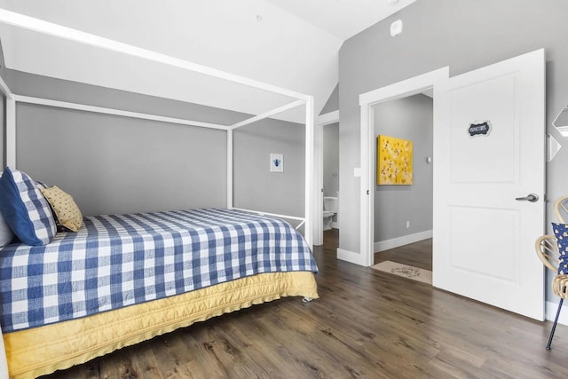 bedroom with dark wood-type flooring and vaulted ceiling