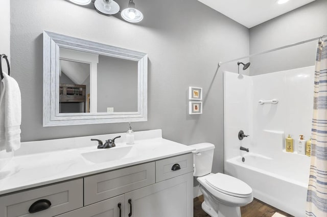 full bathroom featuring shower / bath combination with curtain, vanity, lofted ceiling, wood-type flooring, and toilet