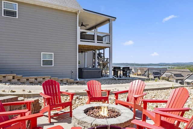 view of patio with ceiling fan, a balcony, and an outdoor fire pit