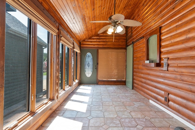 unfurnished sunroom with a barn door, wooden ceiling, vaulted ceiling, and ceiling fan