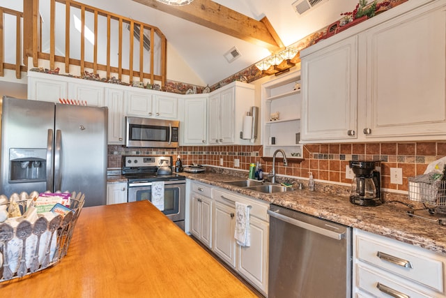 kitchen featuring lofted ceiling with beams, tasteful backsplash, white cabinets, sink, and appliances with stainless steel finishes