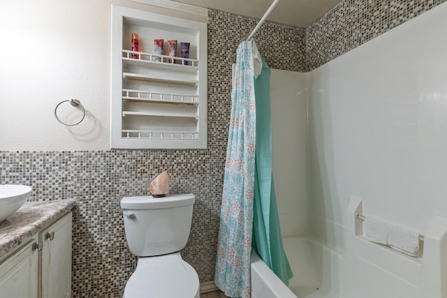 full bathroom with vanity, tile walls, shower / tub combo, and toilet