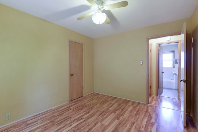 spare room featuring light hardwood / wood-style floors and ceiling fan