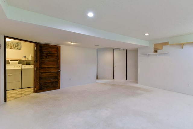 basement with independent washer and dryer and light colored carpet