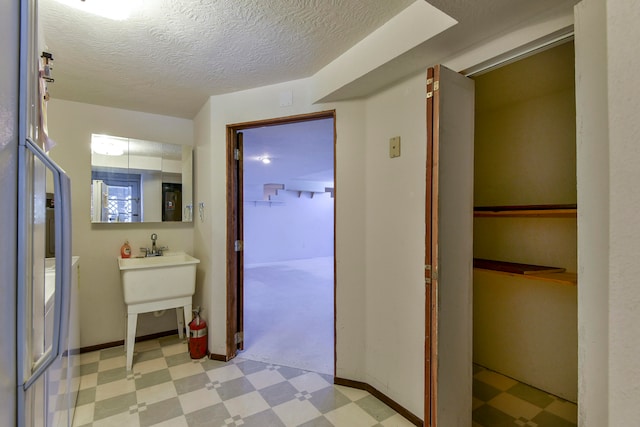 hallway featuring a textured ceiling