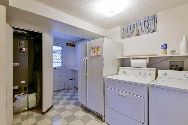 laundry area with washer and dryer and a textured ceiling