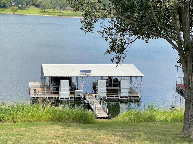 dock area with a water view and a yard