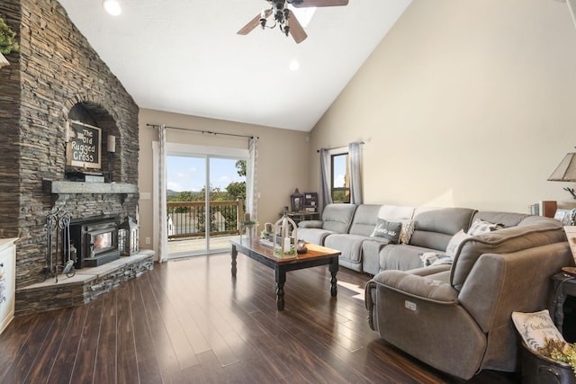 living room featuring ceiling fan, a fireplace, dark hardwood / wood-style floors, and high vaulted ceiling