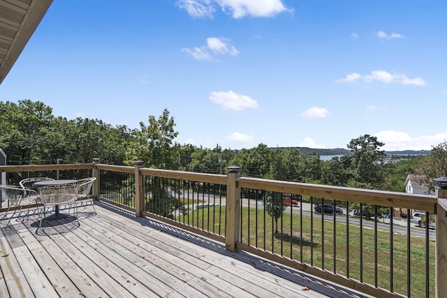 wooden deck with a lawn