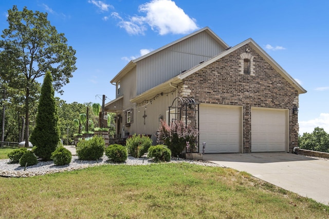 view of side of home with a lawn and a garage