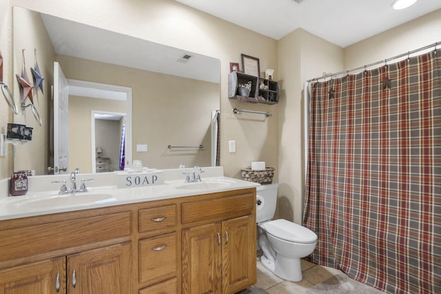 bathroom with tile patterned flooring, walk in shower, vanity, and toilet