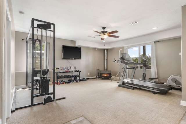 exercise area featuring ceiling fan and carpet