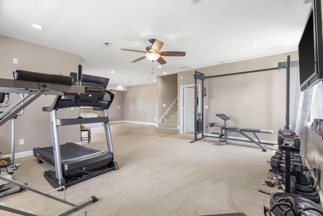 workout area featuring light colored carpet and ceiling fan