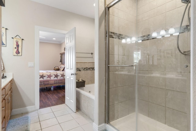 bathroom featuring vanity, tile patterned flooring, separate shower and tub, and crown molding