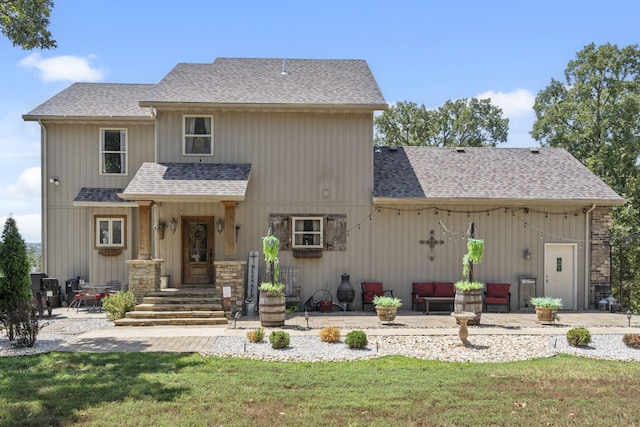 rear view of house featuring a patio area and a yard