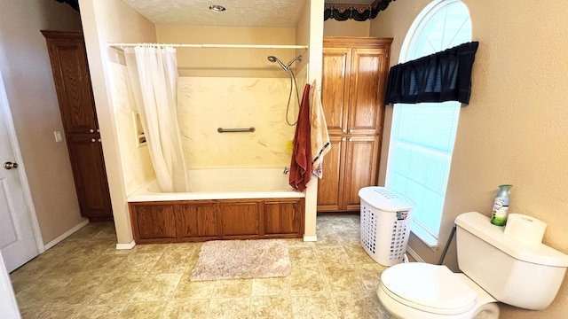 bathroom with a textured ceiling, toilet, and shower / tub combo with curtain