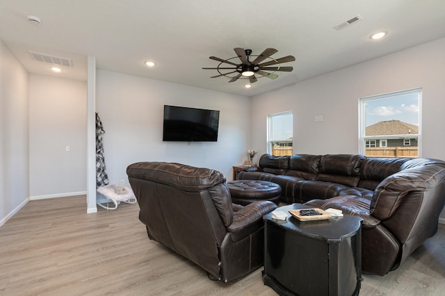 living room featuring light wood-type flooring and ceiling fan