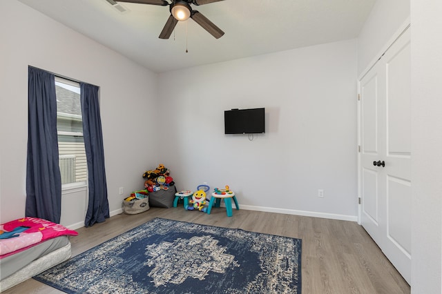 rec room with ceiling fan and light wood-type flooring