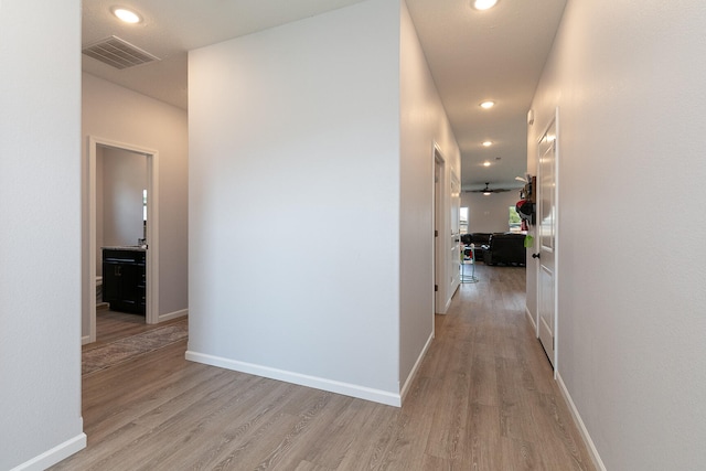 hallway with light hardwood / wood-style flooring