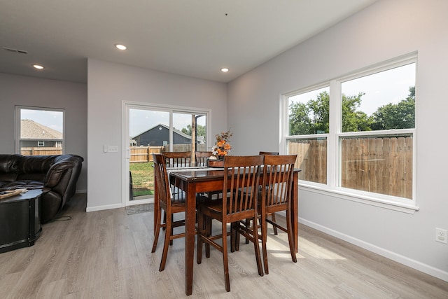 dining space with a wealth of natural light and light hardwood / wood-style floors