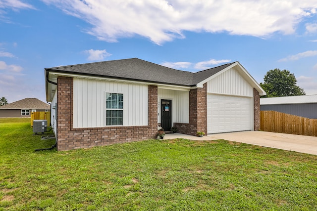 single story home featuring cooling unit, a front yard, and a garage