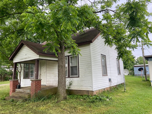 bungalow-style home with a front yard