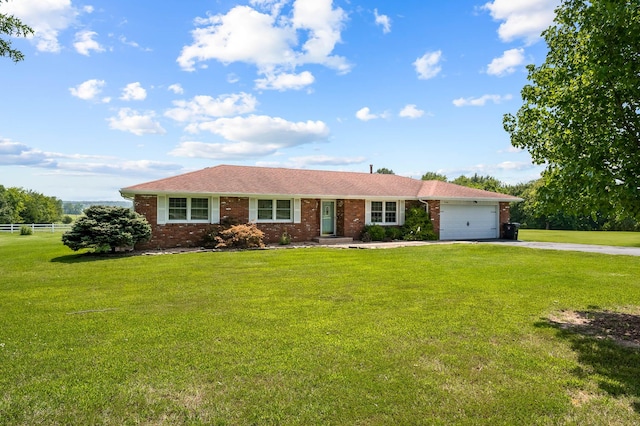 ranch-style home featuring a front lawn and a garage