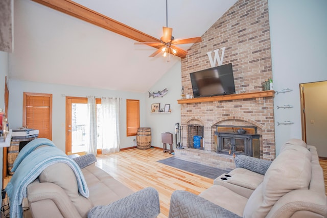 living room featuring high vaulted ceiling, ceiling fan, beamed ceiling, hardwood / wood-style floors, and a fireplace