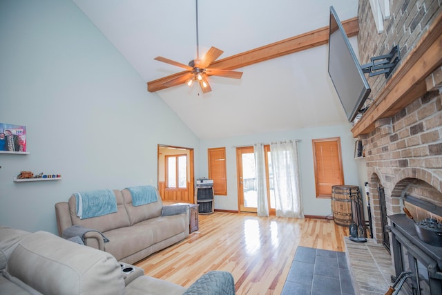 living room with a fireplace, high vaulted ceiling, light hardwood / wood-style flooring, and ceiling fan