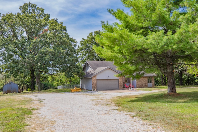 view of front of property featuring a front yard and a garage