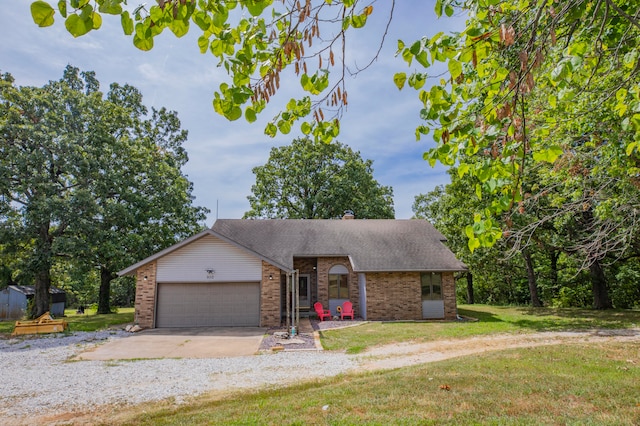 view of front of home with a garage and a front lawn