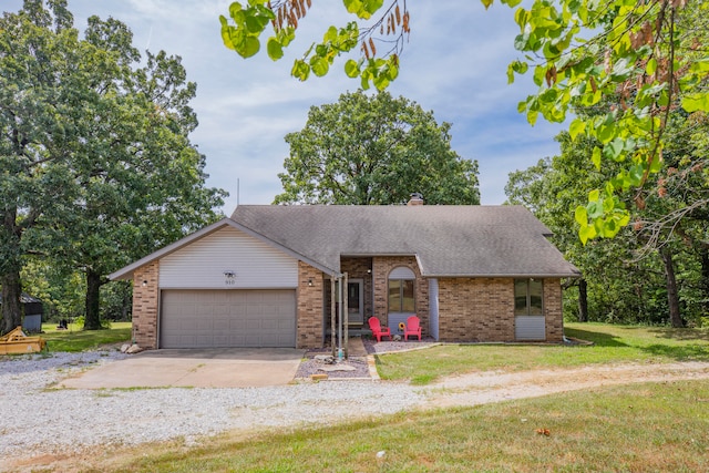 ranch-style house featuring a front yard and a garage