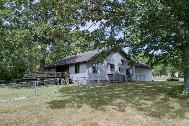 exterior space featuring cooling unit, a wooden deck, and a yard