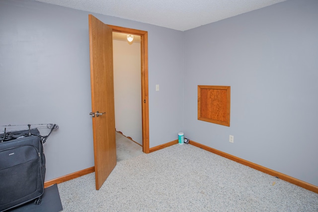 carpeted home office with a textured ceiling